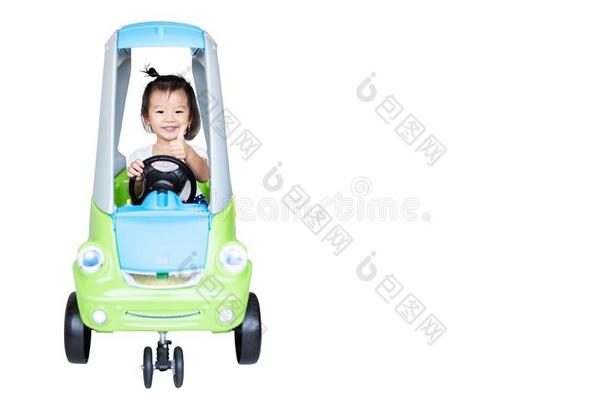 甜的小的亚洲人女孩骑马向小的汽车隔离的向白色的
