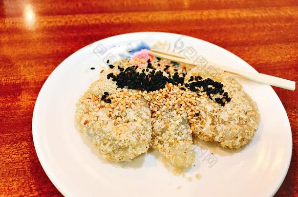 日本人稻蛋糕形成顶部和食糖,黑的和白色的芝麻.