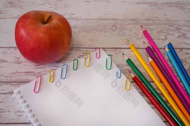 白色的空白的页共空间和富有色彩的铅笔和红色的苹果向