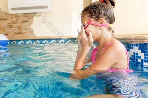 特写镜头肖像关于十几岁的女孩使人疲乏的护目镜在之前游泳