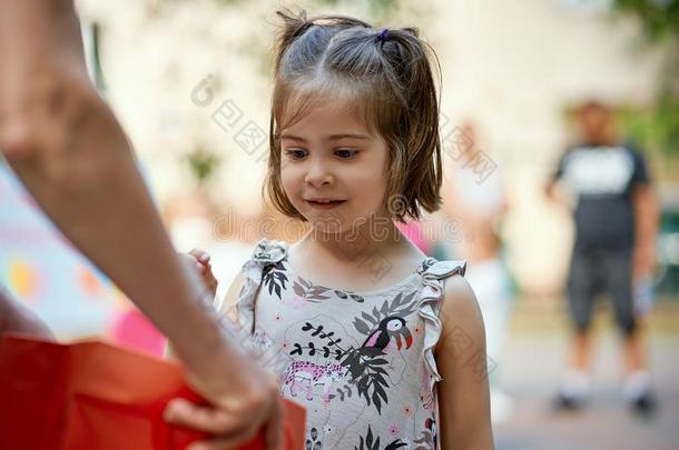 漂亮的小的女孩拿出局彩票票在家庭野餐郊游向