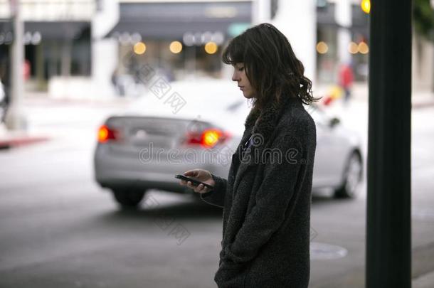 女人使用一Sm一rtphone计算机应用程序W一iting为一Ridesh一re