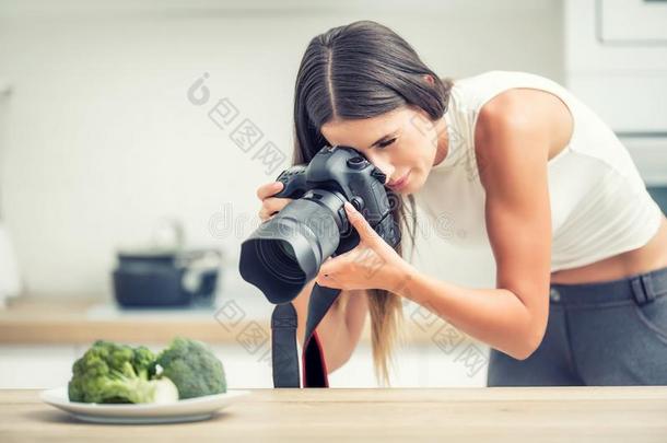 女人专业的摄影盘子和花椰菜.食物照片