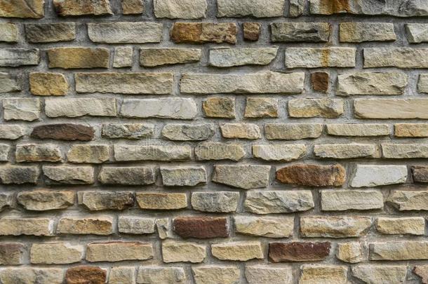 模式关于黄褐色和棕色的石头砖采用墙