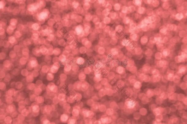 变模糊珊瑚红色的装饰的闪光装饰片.背景影像和胫