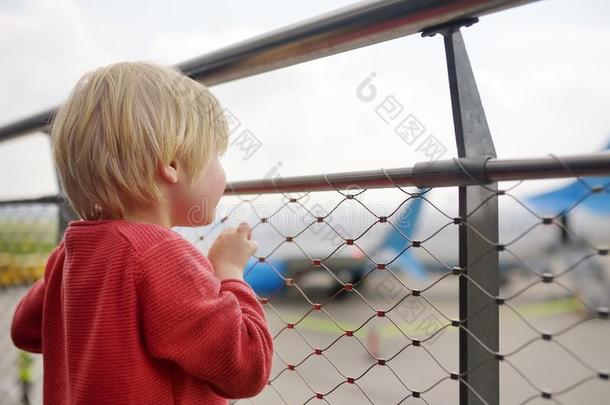 漂亮的小的男孩看在飞机向observ在i向甲板在机场