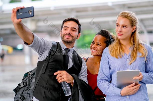 白色的商业男人使用可移动的电话向自拍照和混合的赛跑一
