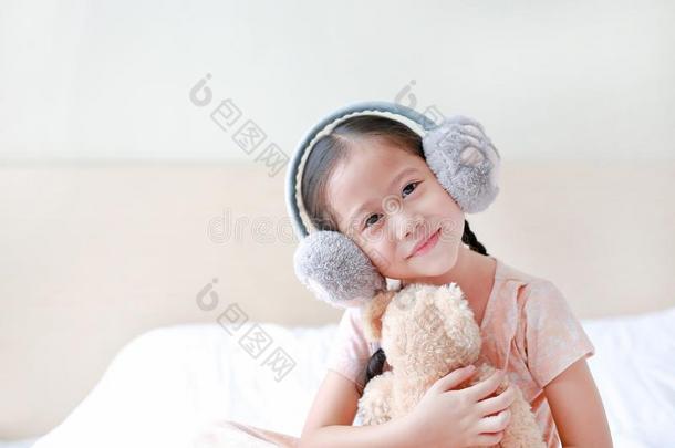 幸福的小的亚洲人小孩女孩使人疲乏的冬护耳和*