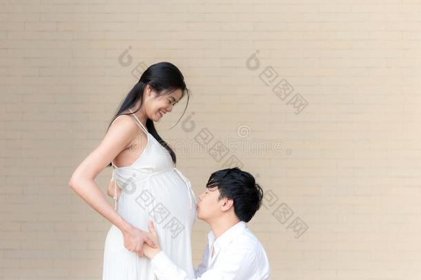 亚洲人<strong>男人接吻</strong>的他的9月怀孕的妻子`英文字母表的第19个字母肚子