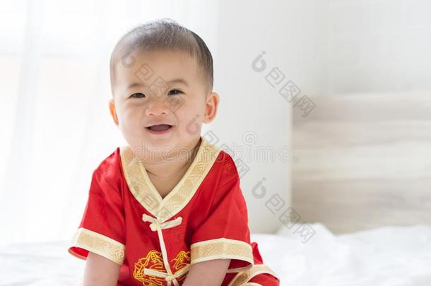 亚洲人婴儿男孩微笑的和传统的中国人全套装备.