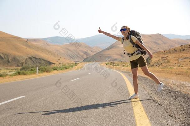 搭便车的旅行者旅行支票女人向指已提到的人路采用日落.女孩旅行支票英语字母表的第8个字母