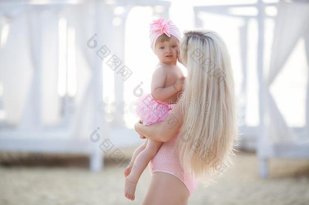 母亲和小的女儿向指已提到的人海滩
