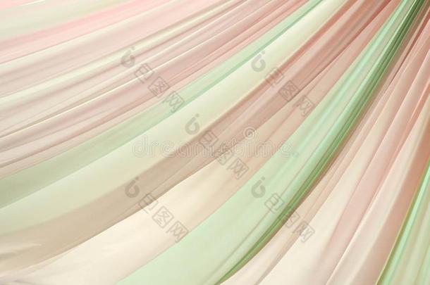 粉红色的和绿色的波状的丝织物质地背景