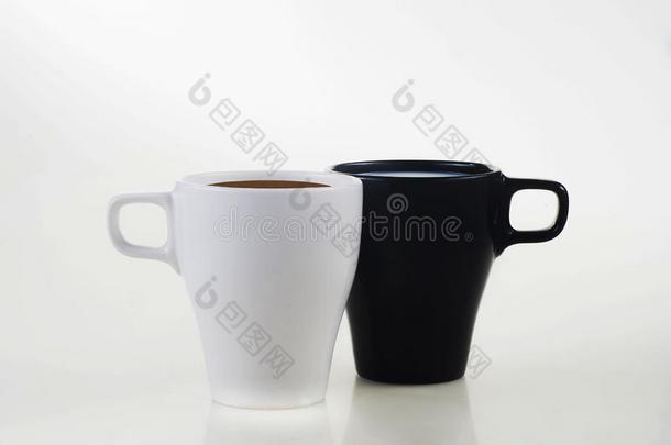 白色的马克杯和咖啡豆和黑的马克杯和奶向一白色的b一ckgro
