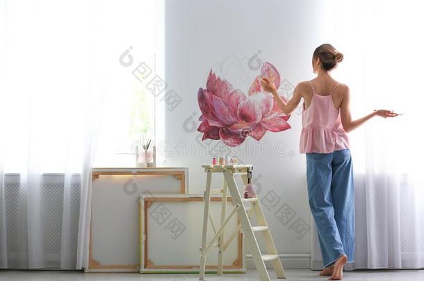 室内装饰师绘画向白色的墙采用房间.内部设计