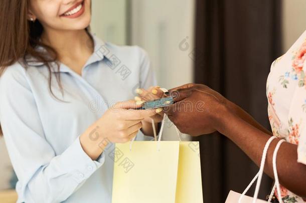 商店助手礼物包装和信誉卡片向顾客,裁切不正的