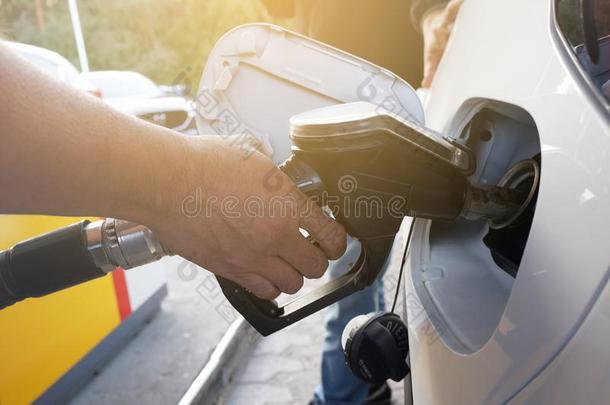 一男人抽吸汽油燃料采用汽车在气体st在ion