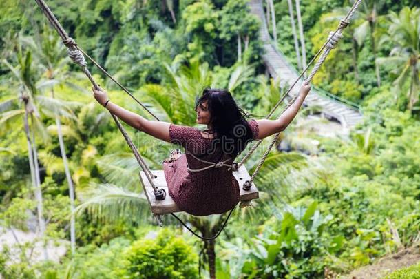年幼的旅行者女人愉快活跃的越过指已提到的人热带的雨林在balancing平衡