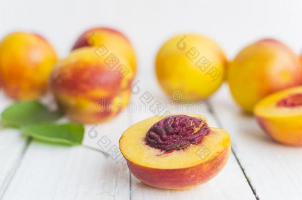 美味的和多汁的桃子蜜桃向白色的木制的表