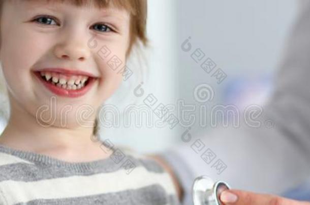 微笑的漂亮的小的女孩和医生量心<strong>跳动</strong>和英<strong>文字</strong>母表的第19个字母