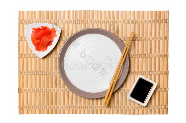 空的圆形的白色的盘子和筷子为寿司和大豆调味汁,