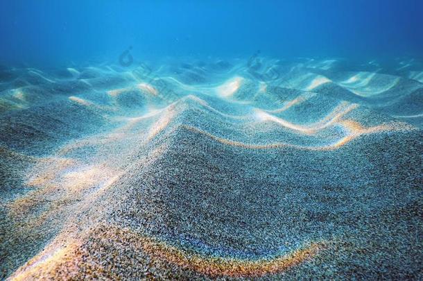 沙的海底部在水中的背景,在水中的蓝色洋