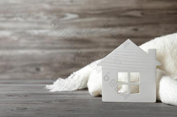 白色的<strong>房屋模型</strong>和围巾向木制的表.暖气装置效率