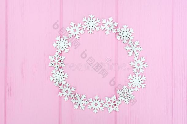 假日圆形的框架使关于圣诞节白色的雪花向粉红色的wickets三柱门