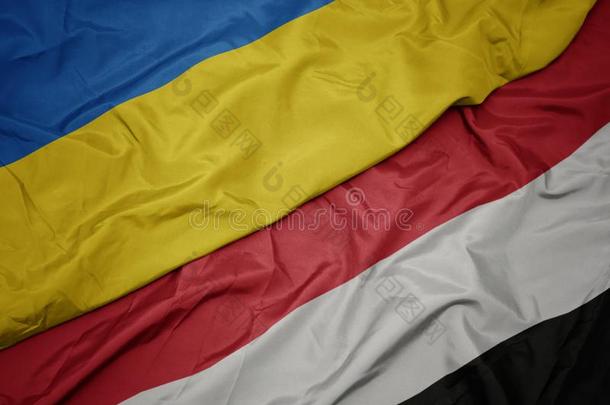 波浪状的富有色彩的旗关于也门和国家的旗关于乌克兰