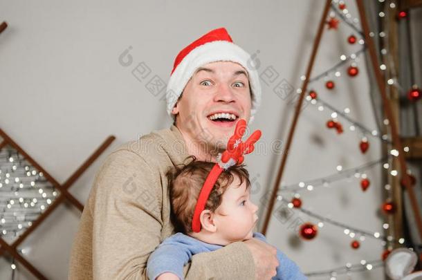 爸爸和儿子热烈地拥抱在指已提到的人圣诞节树.一幸福的小孩和他的爸爸
