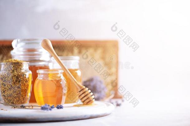 蜜蜂花粉小颗粒,蜂蜜罐子和木制的使滴下的东西,蜂蜜comb向