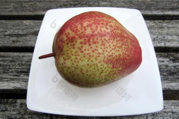 亚洲人洪祥素或红色的芳香的梨梨向白色的盘子