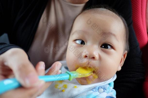 亚洲人男孩和斜视和吃食物