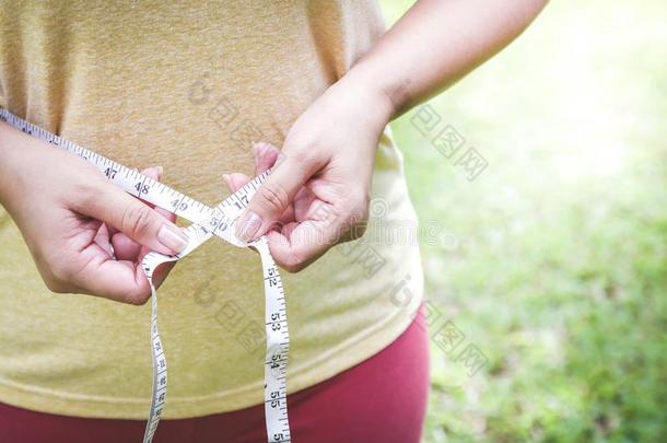 肥的女人用途腰带子测量向看见她大小.