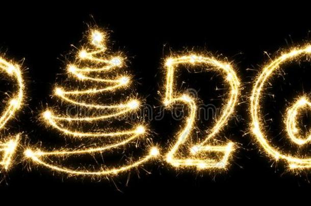 新的年2020和圣诞节树使在旁边闪烁发光物.数字2020