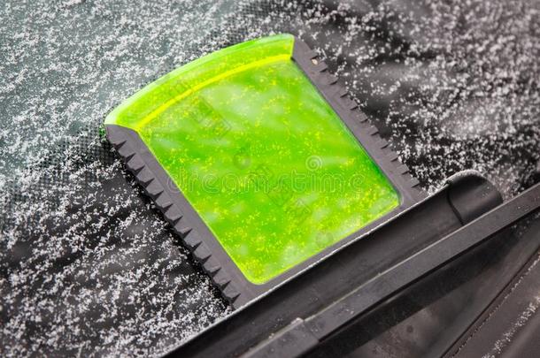 绿色的冰刮刀向汽车挡风玻璃,冬问题采用传送器