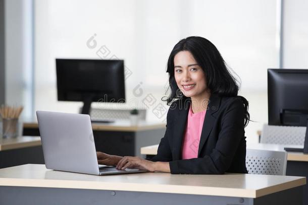 亚洲人女商人使用便携式电脑采用办公室