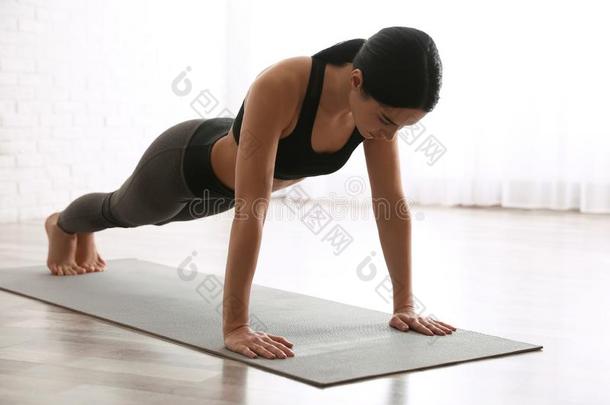 女人开业的木板<strong>瑜珈</strong>的任何一种姿势采用瑜伽工作室.Phalank<strong>瑜珈</strong>的任何一种姿势使摆姿势