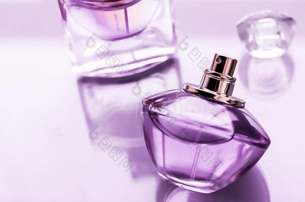 紫色的香水瓶子向有光泽的背景,甜的花的香味,