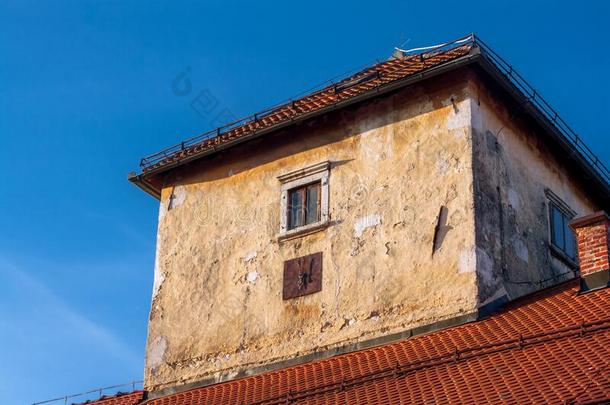 老的残破的房屋塔和褪色和刨成片建筑物的正面
