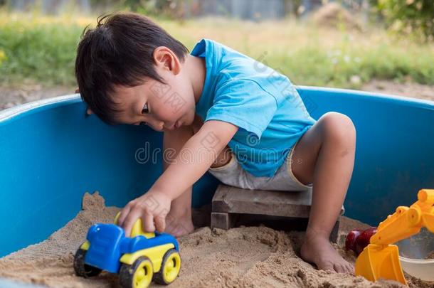 亚洲人小的小孩男孩演奏汽车玩具和s和采用s和box胜过