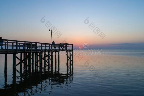 日落越过可移动的湾向指已提到的人亚拉巴马海湾海岸海景画在将饵食<strong>轻放</strong>水面