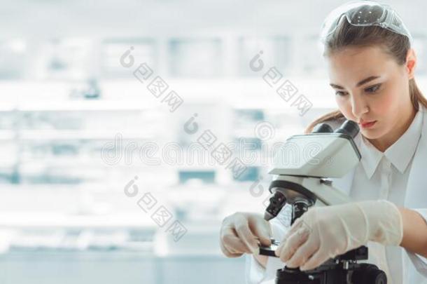 医学的科学家研究员使用显微镜采用实验室,我