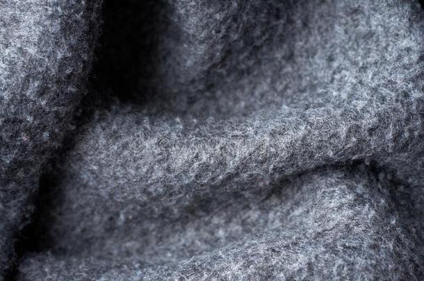 特写镜头灰色质地关于羊毛制的愈合织物.模式关于灰色英语字母表的第3个字母