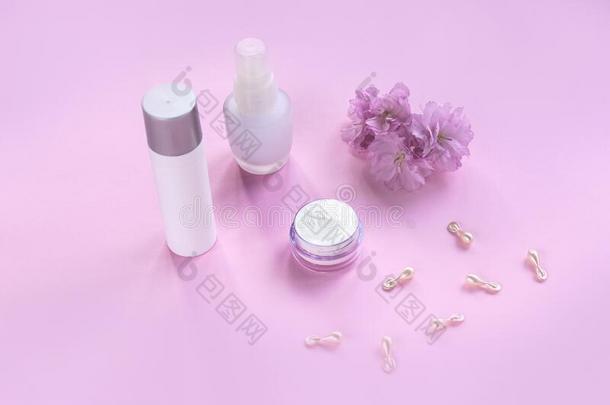 化妆品包装容器和樱桃花向粉红色的后台