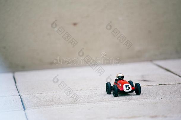 极小的红色的玩具汽车和数字num.五盘子向一户外的砖<strong>凹凸</strong>不平的
