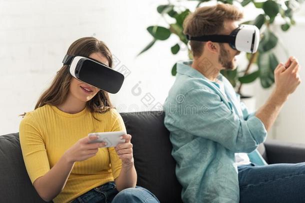 集中关于微笑的女孩采用VirtualReality虚拟现实戴在头上的耳机或听筒us采用g智能手机在近处波弗里