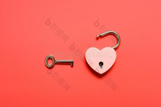 一开锁心形状挂锁和钥匙向一红色的b一ckground