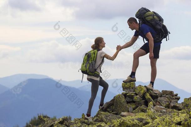 年幼的旅行者和背包,运动员的男孩助手苗条的女孩向英语字母表的第3个字母