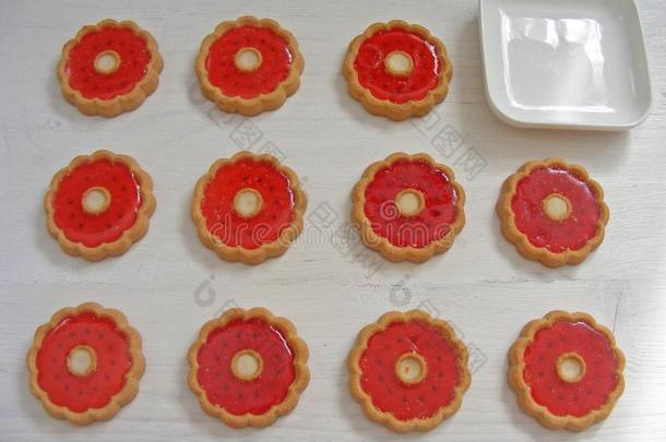 甜饼干和红色的果冻花里面的向白色的背景